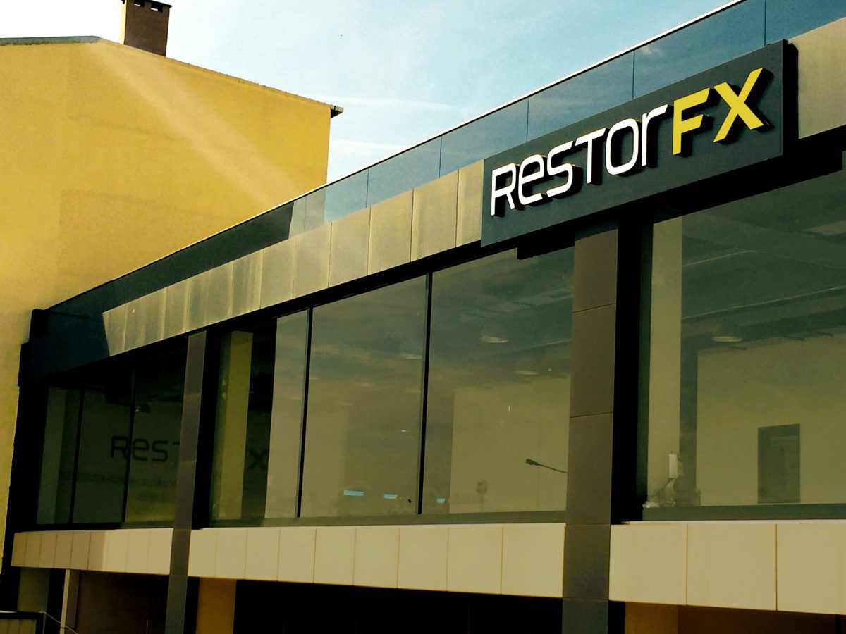 Front facade of RestorFX Turkey with light rays shining on its modern and elegant signage and glass windows